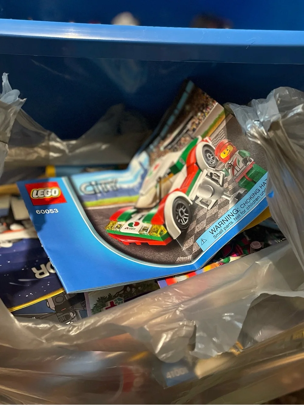 Big Tub full of Legos with a bag full of  Different Guide Books!